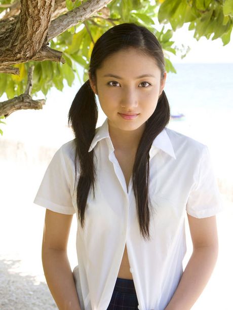 Adorable little asian chick hanging out at the beach in a bikini